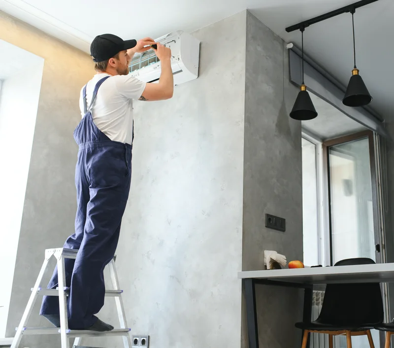 Man fixing the indoor unit of an ac